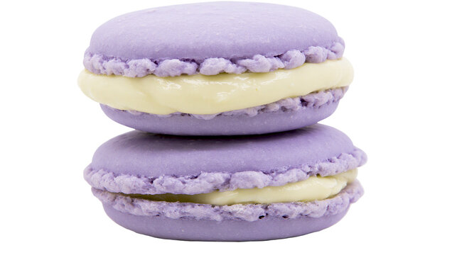 Two stacked lavender macarons with creamy yellow filling, isolated on transparent background