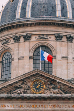 Historic dome of the Sorbonne Chapel with French flag waving, Paris, France