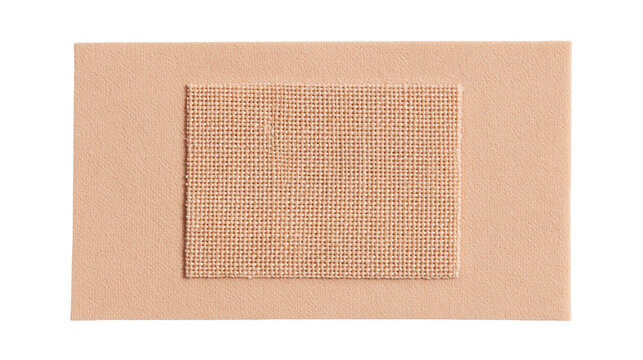 Rectangular beige fabric bandage with woven gauze pad, isolated on transparent background