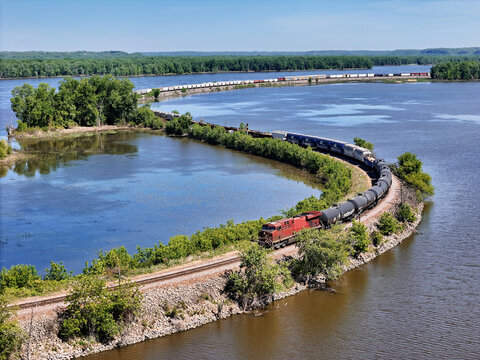 Locomotive pulling freight curving Along the Mississippi River