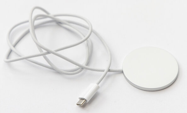 White magnetic wireless charger with connected braided cable