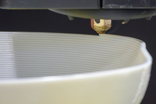Close up operation of additive manufacturing process by 3D printing machine