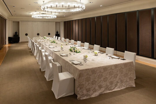 Luxury Executive Boardroom Dining Setup with Elegant Long Table and Chandeliers