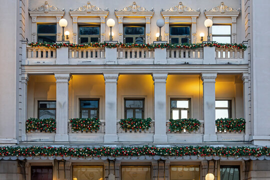 Balconies and terraces on retro building facade wall decorated for winter festive period