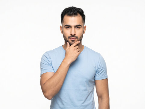 young indian man in a thoughtful pose showing early stage hair thinning isolated on white background for alopecia awareness dermatology and hair care concepts