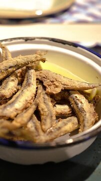 Vertical video close-up shot of crispy fried boquerones, spanish tapas