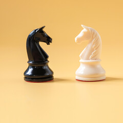 Black and White chess knight horse piece on color background.Business game. © amnarj2006