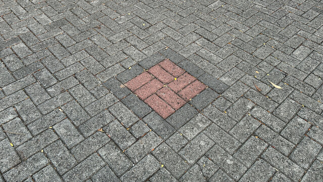 paving block with red square motif