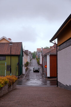 Car driving down a narrow street in old town