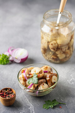 Homemade pickled mushrooms in glass bowl on the  table. Fermented healthy food.