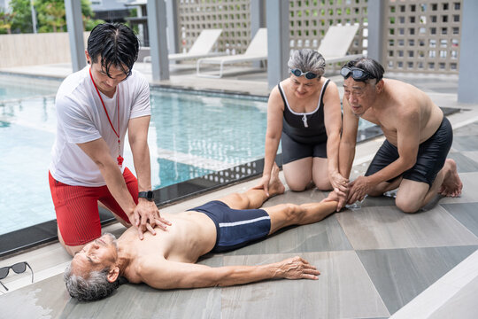 elderly man drowns in a pool,lifeguard rescue first aid help basic life support by the poolside, two senior friends sitting beside look in shock