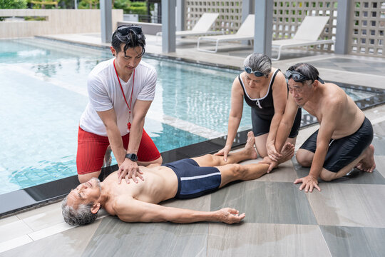 elderly man drowns in a pool,lifeguard rescue first aid help basic life support by the poolside, two senior friends sitting beside look in shock
