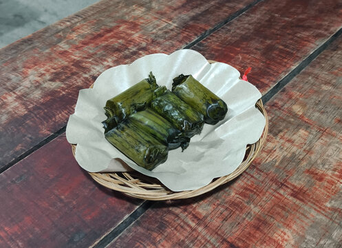 Traditional Indonesian lemper wrapped in banana leaves is ideal for restaurant menus, culinary tours, hospitality marketing, and commercial food publications.