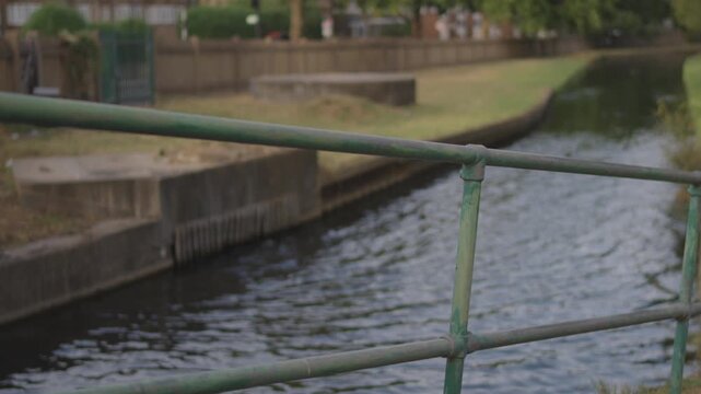 Green Footbridge Railing Rack Focus Over Narrow Canal