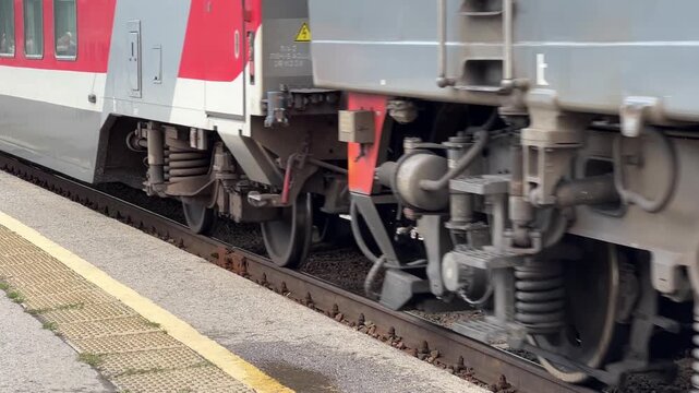 Ulyanovsk, Russia, July 30, 2026: close-up of the metal wheels of a double-decker Russian Railways (RZD) train arriving at the station