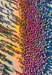 Fototapeta premium Aerial View of a Large Crowd Celebrating Holi Festival with Vibrant Colors and Long Shadows on Pavement
