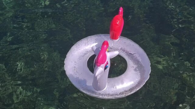 Transparent unicorn inflatable float drifting on crystal clear sea water