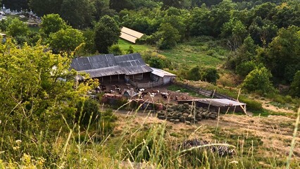 An aerial view of a traditional sheepfold and farmyard in the scenic rural hills of Iasi, Romania. Ideal for pastoral and agricultural themes. © Amarandei