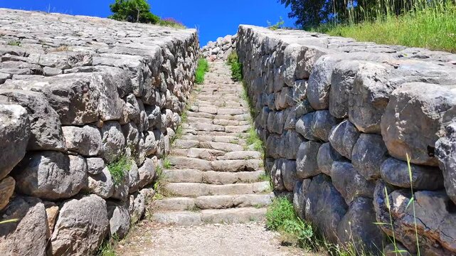 A monumental stone staircase climbs up the Yerkapı rampart, flank-lined by heavy stone retaining walls at ancient Hattusa, Turkey.