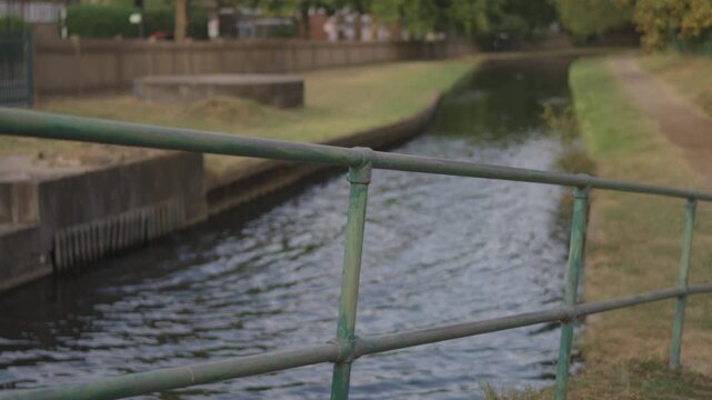 Footbridge Railing Over Canal, Towpath and Grass Bank