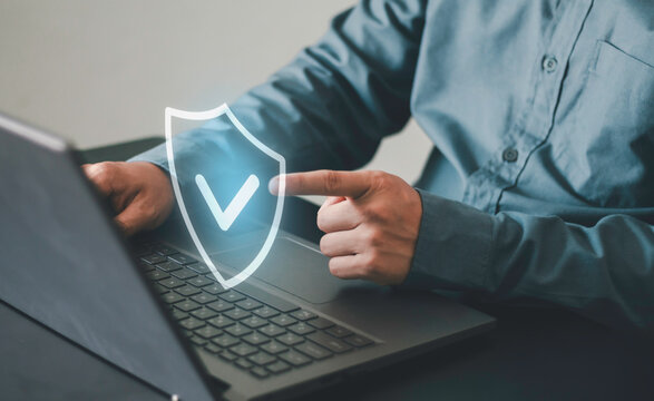 Cybersecurity with shield check icon over laptop, symbolizing secure access, data protection, network security, privacy, cyber defense, compliance, authentication and trusted digital technology.