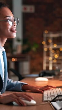 Computer, night or copywriter in office with glasses, draft edit or source feedback for article. Bokeh, woman or journalist in agency with tech, fact check or publication research in late evening.