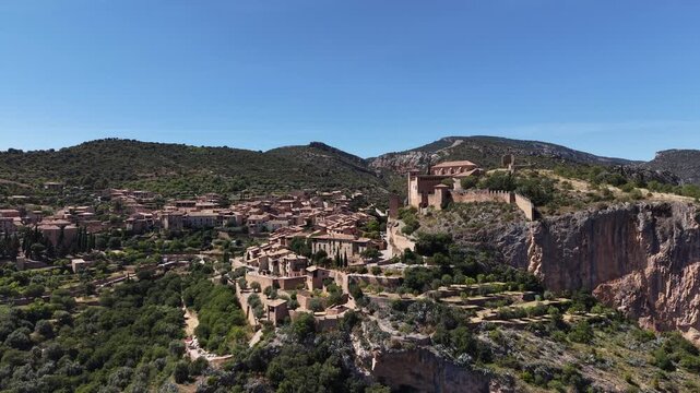 Aerial shot approaching castle in town of Alqu&eacute;zar, set in beautiful landscape. Huesca, Spain. 