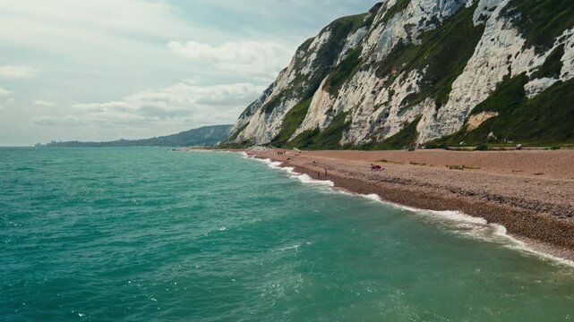 View from Pier Over Yellow Beach, White Cliffs and Turquoise English Channel Water in Dover