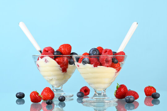 Glasses with yogurt and fresh berries