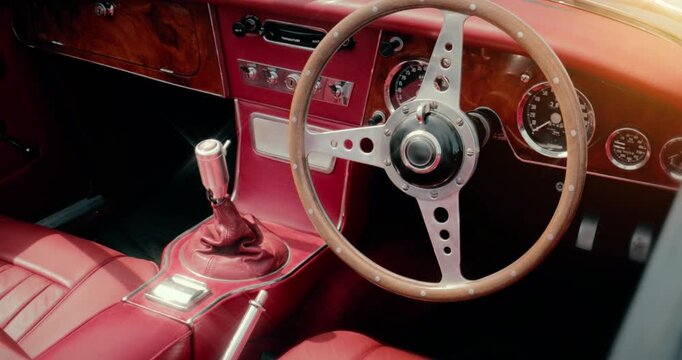 Car interior - classic vintage luxury motor vehicle steering wheel. Sports car with retro style dashboard.