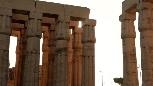 Sun shines through columns in square at Luxor Temple