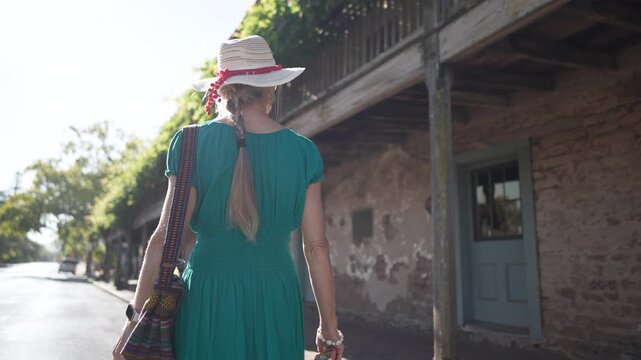 A senior woman visits the Blue Wing Inn museum and enjoys the sunny weather while exploring the historic site in Sonoma California.