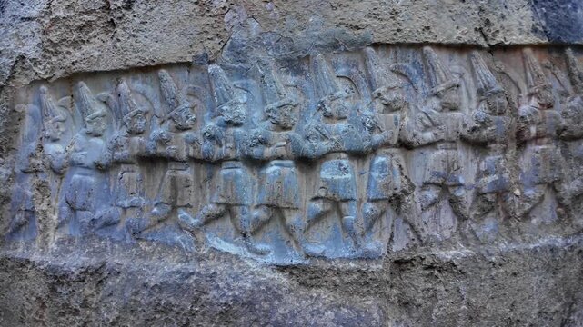 Twelve Hittite underworld gods march in a procession, carved in rock relief at the Yazılıkaya sanctuary near ancient Hattusa.