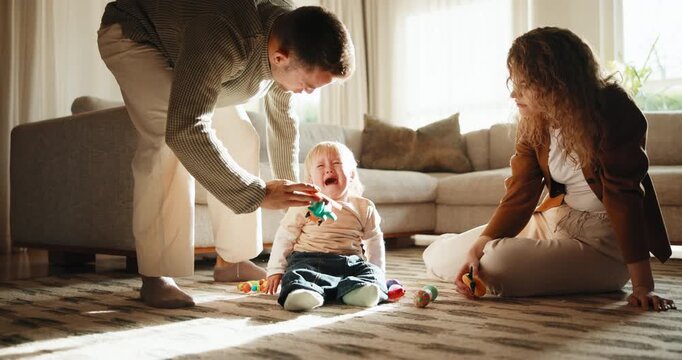 Parents, toys and baby crying in house with help, tired or emotions for early childhood development. Mother, father and support sad toddler boy in living room with tantrum, fatigue and distraction.
