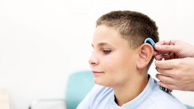 Video of a child undergoing a hearing aid color fitting at a medical center. Concept of choosing the color or colors of hearing aids.