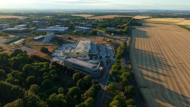 Aerial view of Moderna Innovation and Technology Center surrounded by fields and trees in Harwell Oxford, England, United Kingdom.