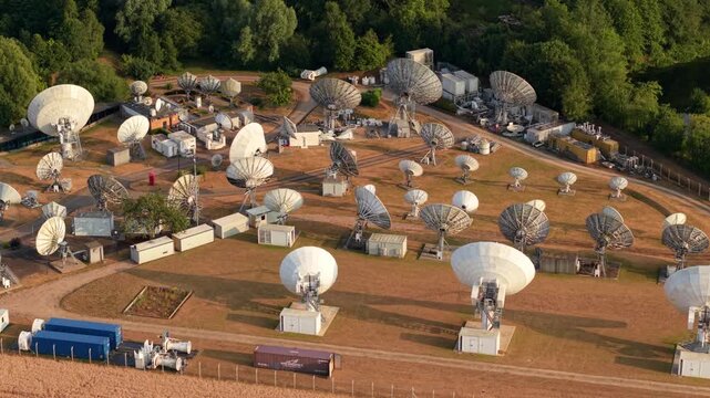 Aerial view of satellite dish array of a communications network surrounded by trees and infrastructure in Rugby, England, United Kingdom.