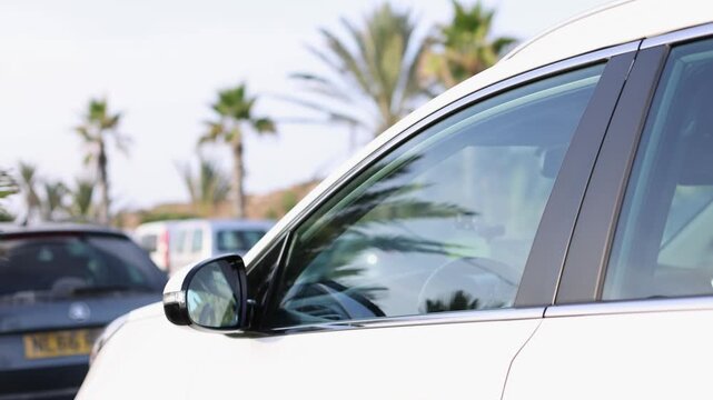 Automatic unfolding side mirror on parked modern car. 4k