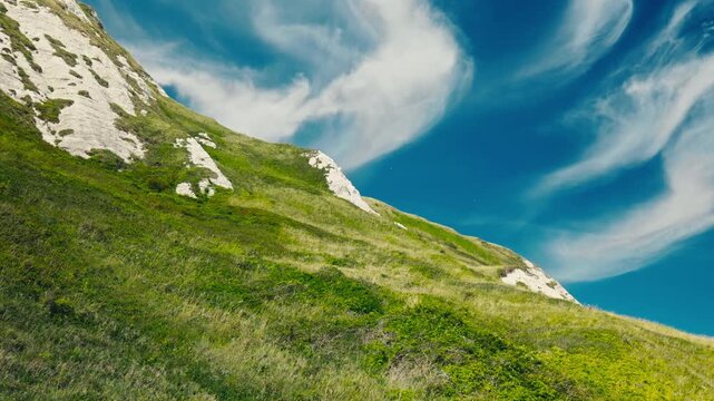 Low Angle View of White Cliffs Covered with Bright Green Grass in Dover