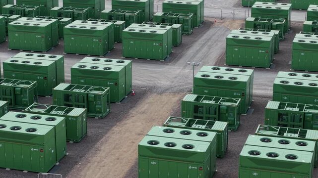 Aerial view of Hams Hall Substation Battery Energy Storage Systems with rows of green containerized units for grid resilience in Birmingham, England, United Kingdom.