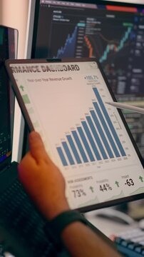 Financial Analytics Chart Displaying Business Revenue Growth Progress Performance Screen Tablet. Close-up view of a person using a stylus pen to analyze statistical data, bar graphs