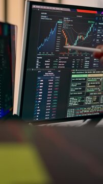 Crypto Candlestick Chart Downtrend Financial Analytics Tablet Screen Trading Dashboard. Close-up view of a business analyst pointing at falling market graphs, cryptocurrency statistics
