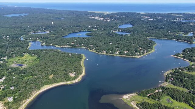 The shallow waters of Pleasant Bay are seen from a bird's eye view on a summer day. This beautiful body of water, fed by the Atlantic Ocean, is a part of Orleans and Chatham, Cape Cod, Massachusetts.
