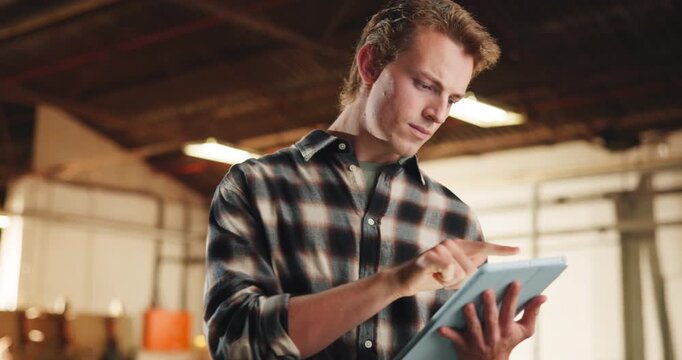 Carpentry, scroll and man in warehouse with tablet, inspection or reflection for timber production. Furniture order, digital tech and person with thinking for inventory, lumber business or woodwork