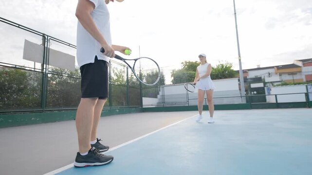 Professional tennis players playing doubles match on a hard court