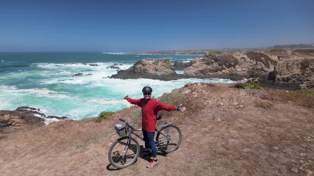 A woman rides her bike along the cliffs of Fort Bragg. She enjoys the views and the sound of waves from the Pacific Ocean.