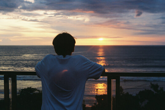 Watching the Sunset Over the Ocean From a Peaceful Balcony