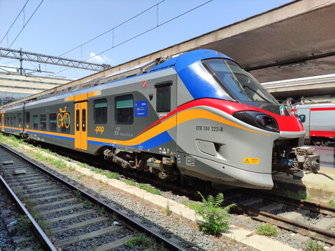 Rome, Italy - July 20, 2026: Modern electric train ETR 101 272-B with bicycle symbol parked on tracks at a railway station under clear blue sky