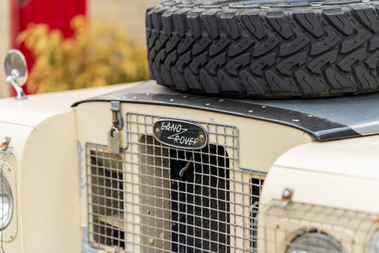 Land Rover Series IIA off-road vehicle featuring its iconic grille, hood-mounted spare tire, and classic badge, symbolizing exploration, adventure, and durable automotive heritage