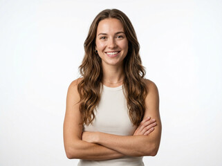 Fototapeta premium A Beautiful Young Woman with Natural Freckles and Long, Wavy Brown Hair Smiles Confidently with Arms Crossed